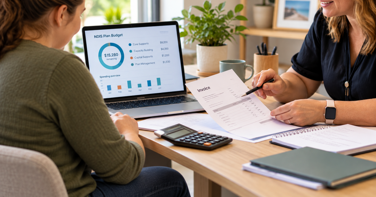 A plan manager discusses an NDIS budget on a laptop and reviews an invoice with a participant.